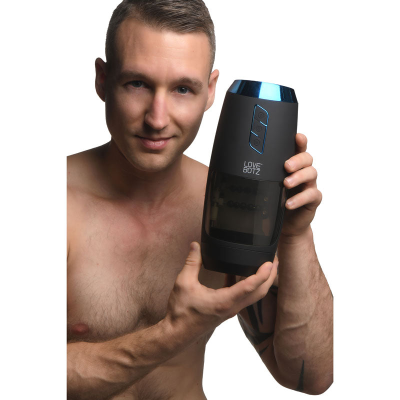 LoveBotz The Milker Slider 18X Stroking Masturbator - USB Rechargeable Stroking Masturbator held by a model