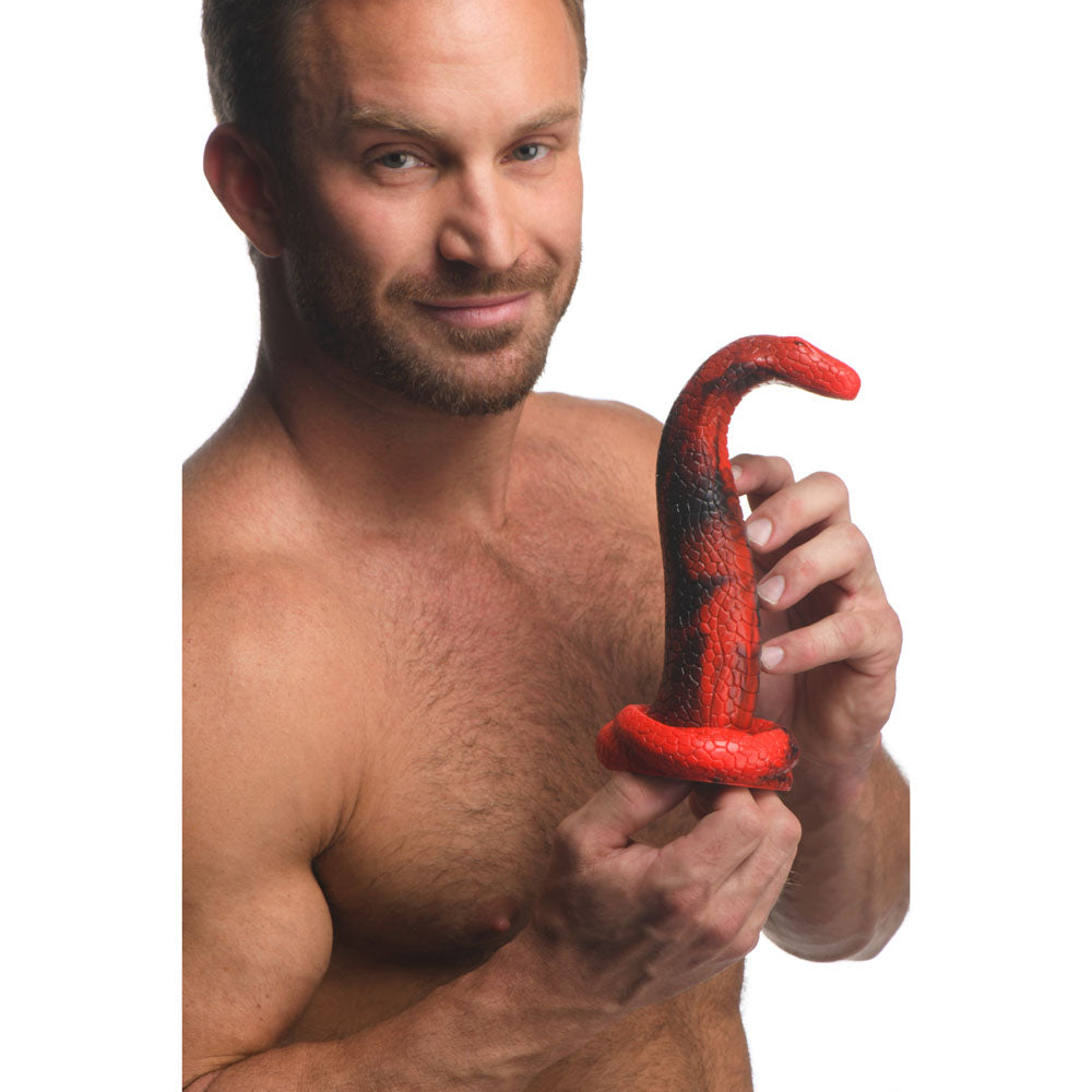 Man holding the Creature Cocks King Cobra Silicone Dildo - 21.4 cm Fantasy Dildo in red and black colors.