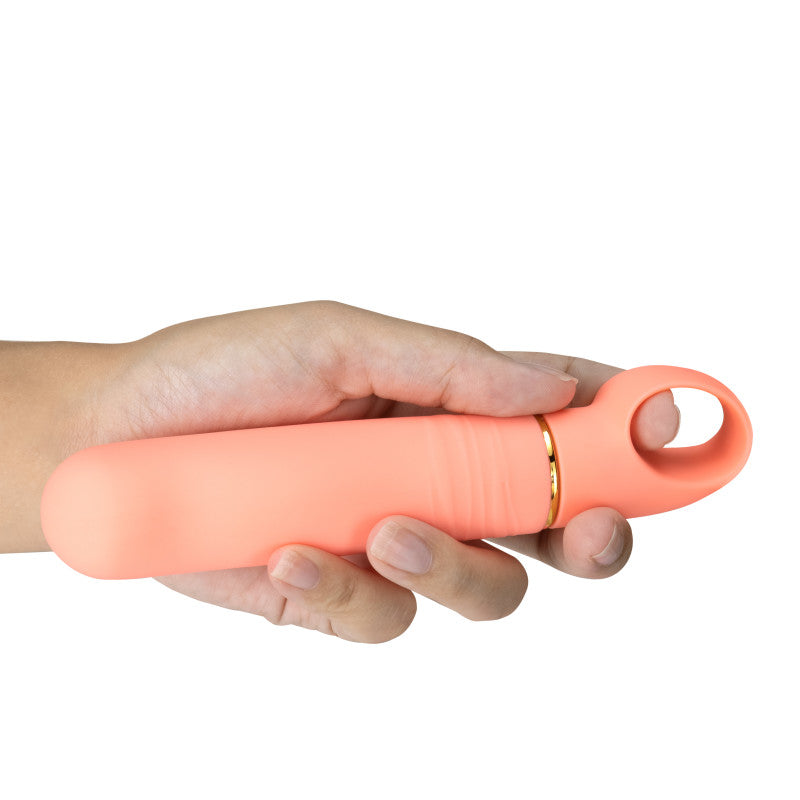 Person holding the Aria Smokin' AF - Coral 15.2 cm Vibrator, showcasing its sleek design and ergonomic features.