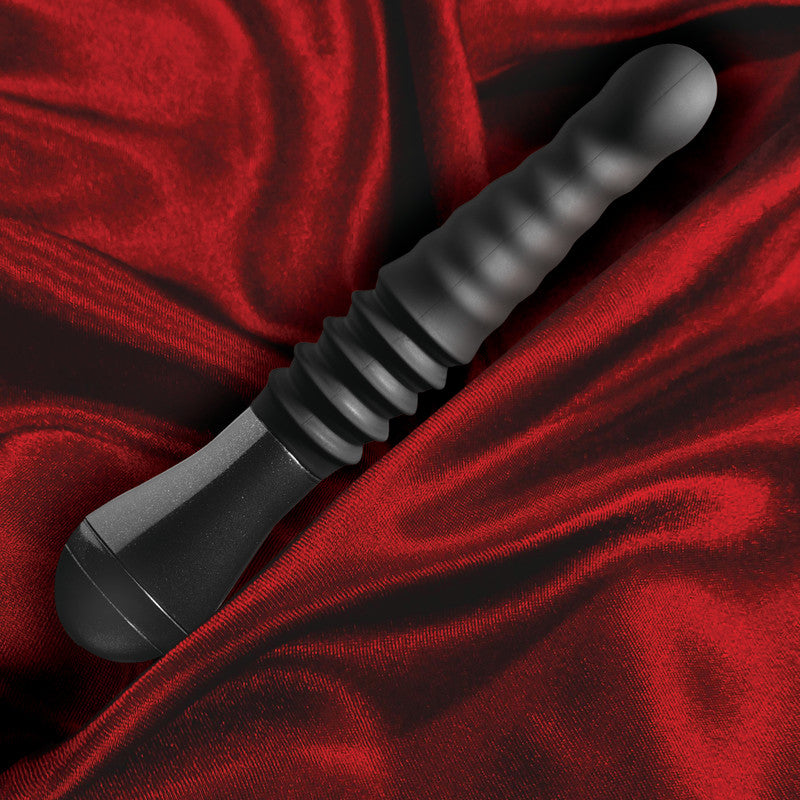 Temptasia Lazarus thrusting dildo for G spot stimulation on red satin fabric background, showcasing its sleek design and ribbed texture.