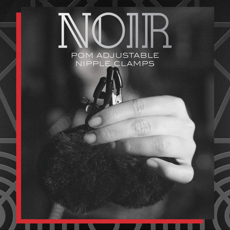 Noir Pom Adjustable Nipple Clamps - Black Furry Nipple Clamps in hand with fluffy cover for sensation play.