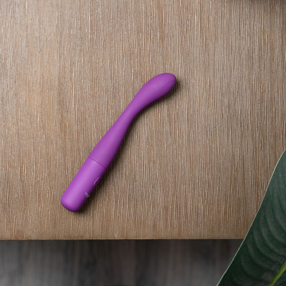 Maia CHELSI -  17.8 cm USB Rechargeable Vibrator in purple on a wooden surface.