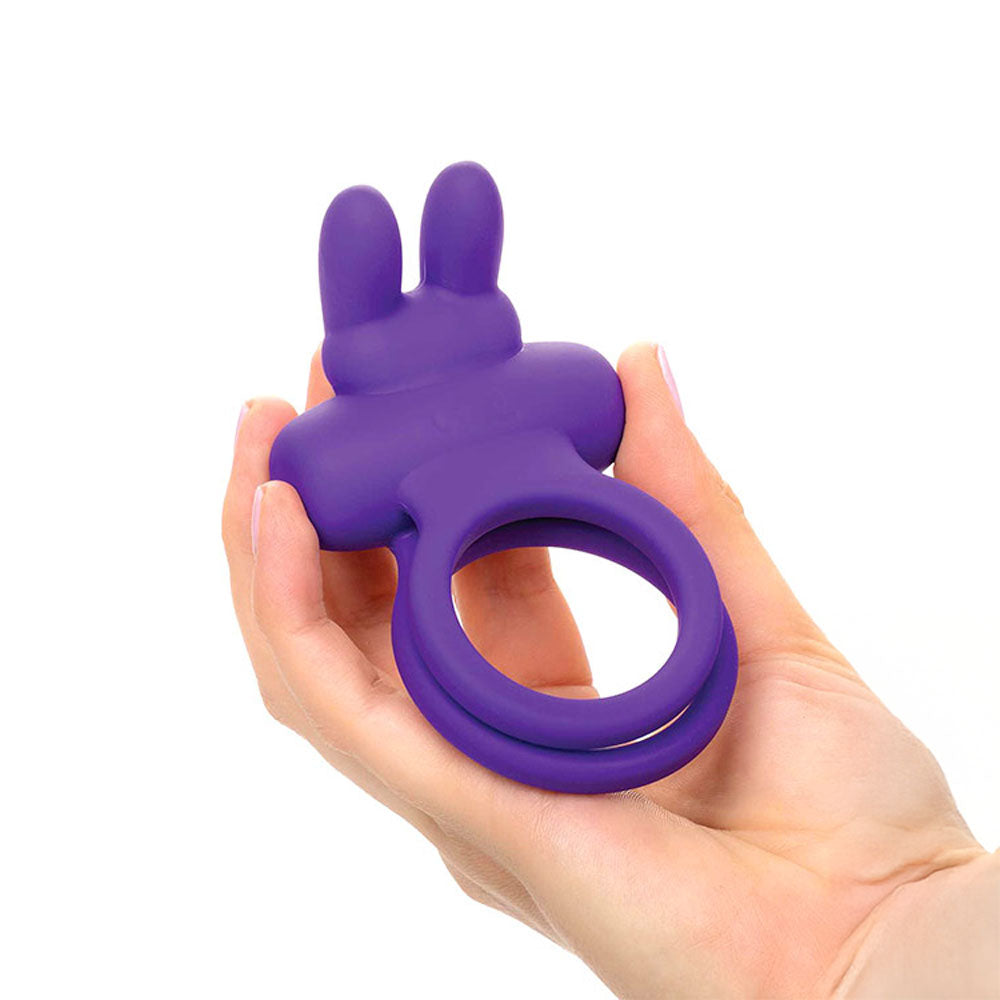 Adam & Eve ROCKIN' RABBIT -  USB Rechargeable Cock & Balls Ring in hand showcasing its design and silicone material.