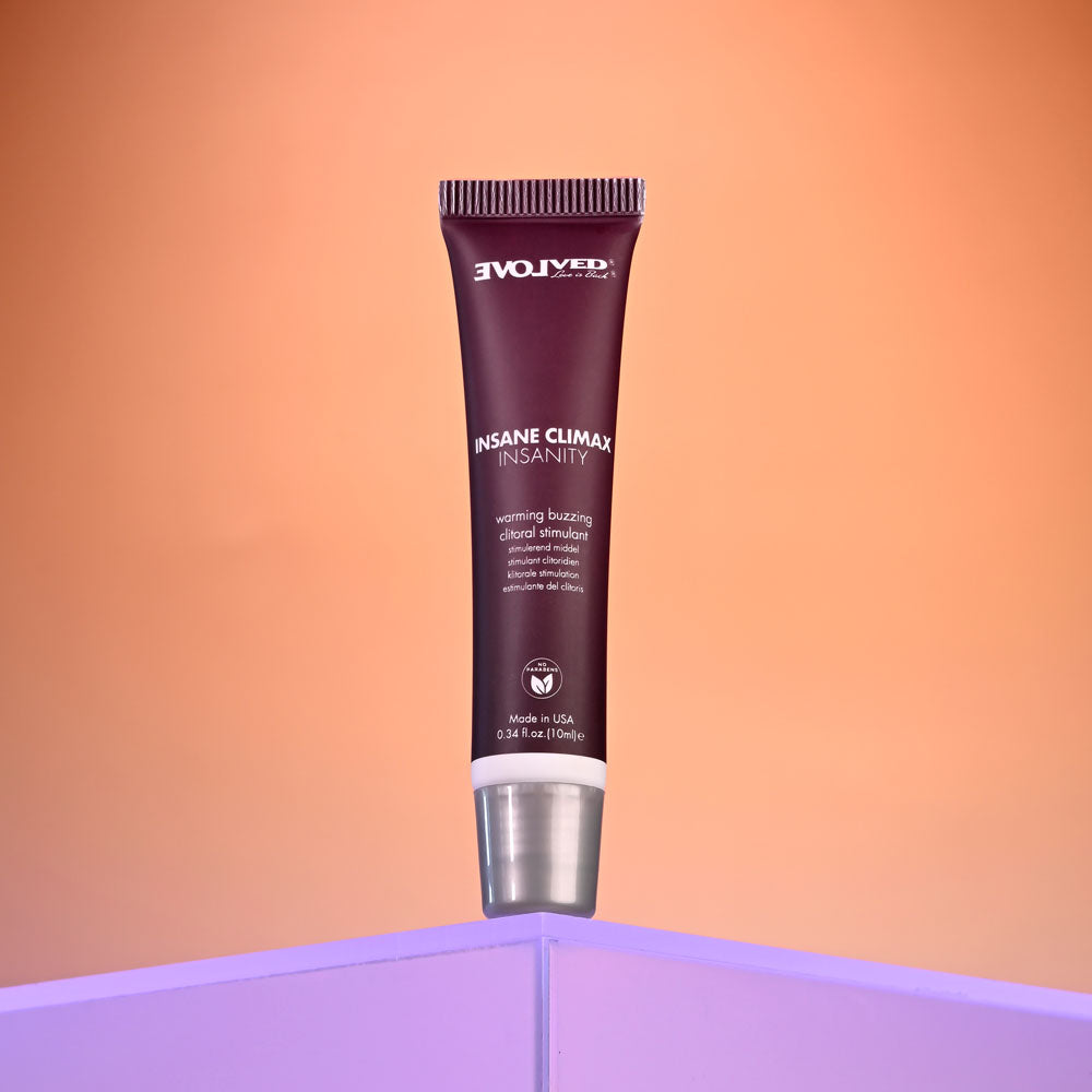 Evolved INSANE CLIMAX - INSANITY - Warming Buzzing Clitoral Stimulation Gel - 10 ml on a colorful background.