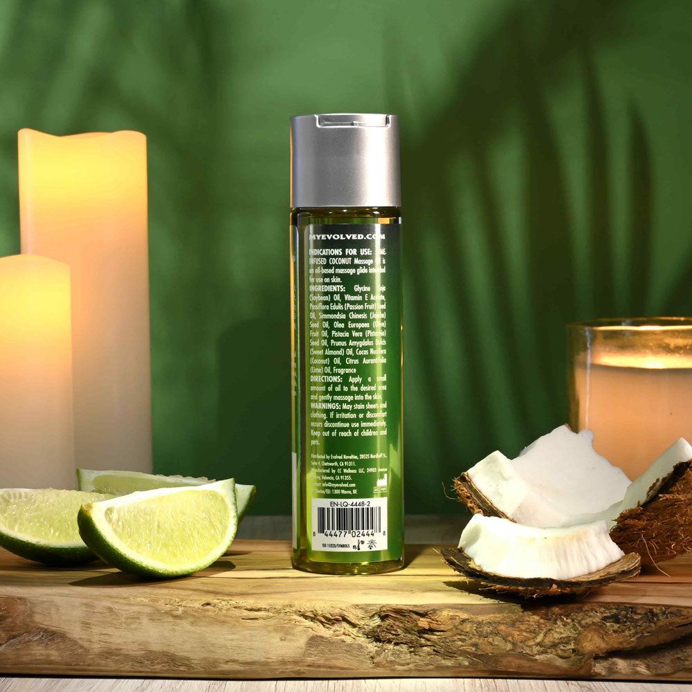 Evolved ANOINT PERFUMERY - Lime Infused Coconut - Lime Infused Coconut Massage Oil - 120 ml Bottle showcased with lime and coconut.