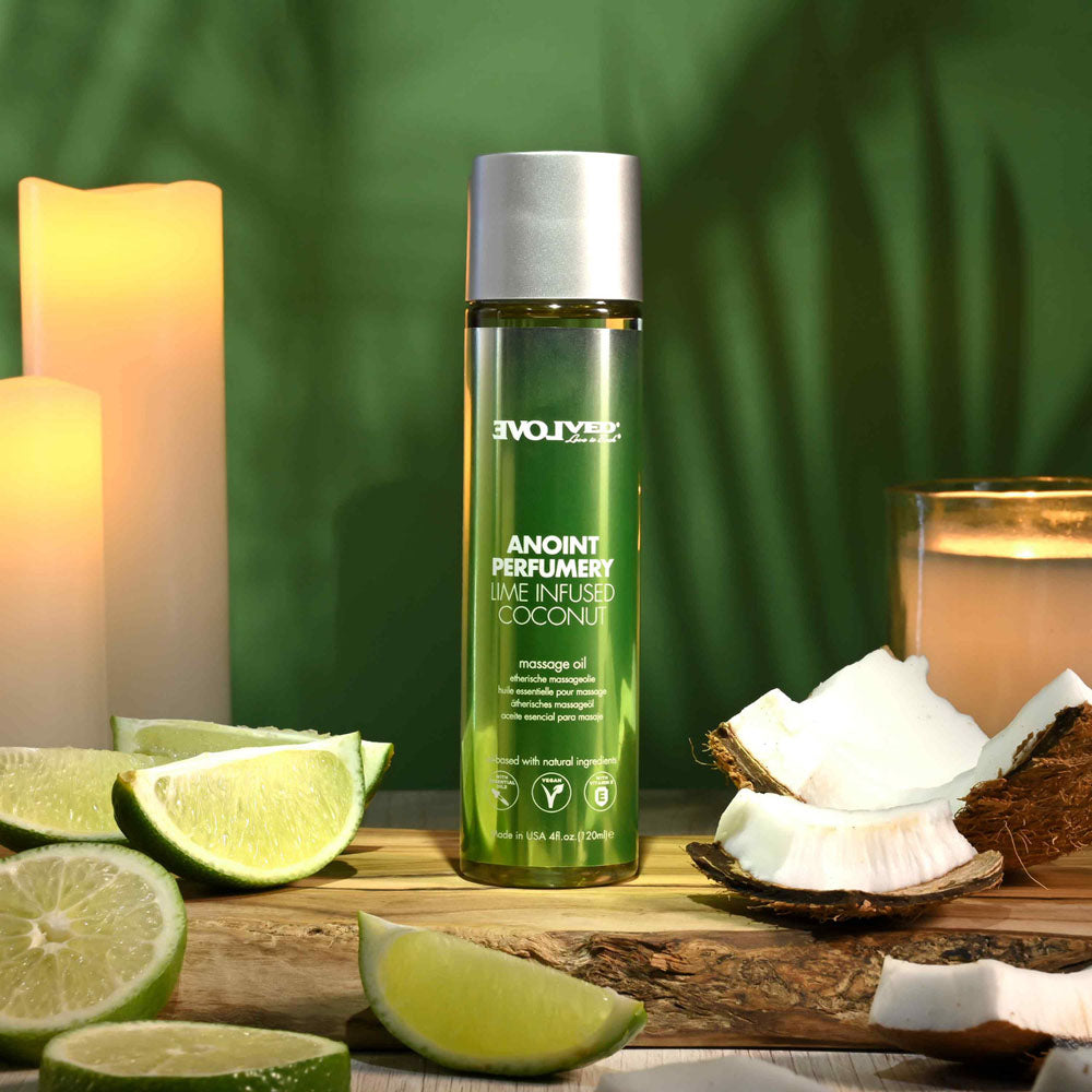 Evolved ANOINT PERFUMERY - Lime Infused Coconut - Lime Infused Coconut Massage Oil - 120 ml Bottle with lime and coconut on a wooden table.