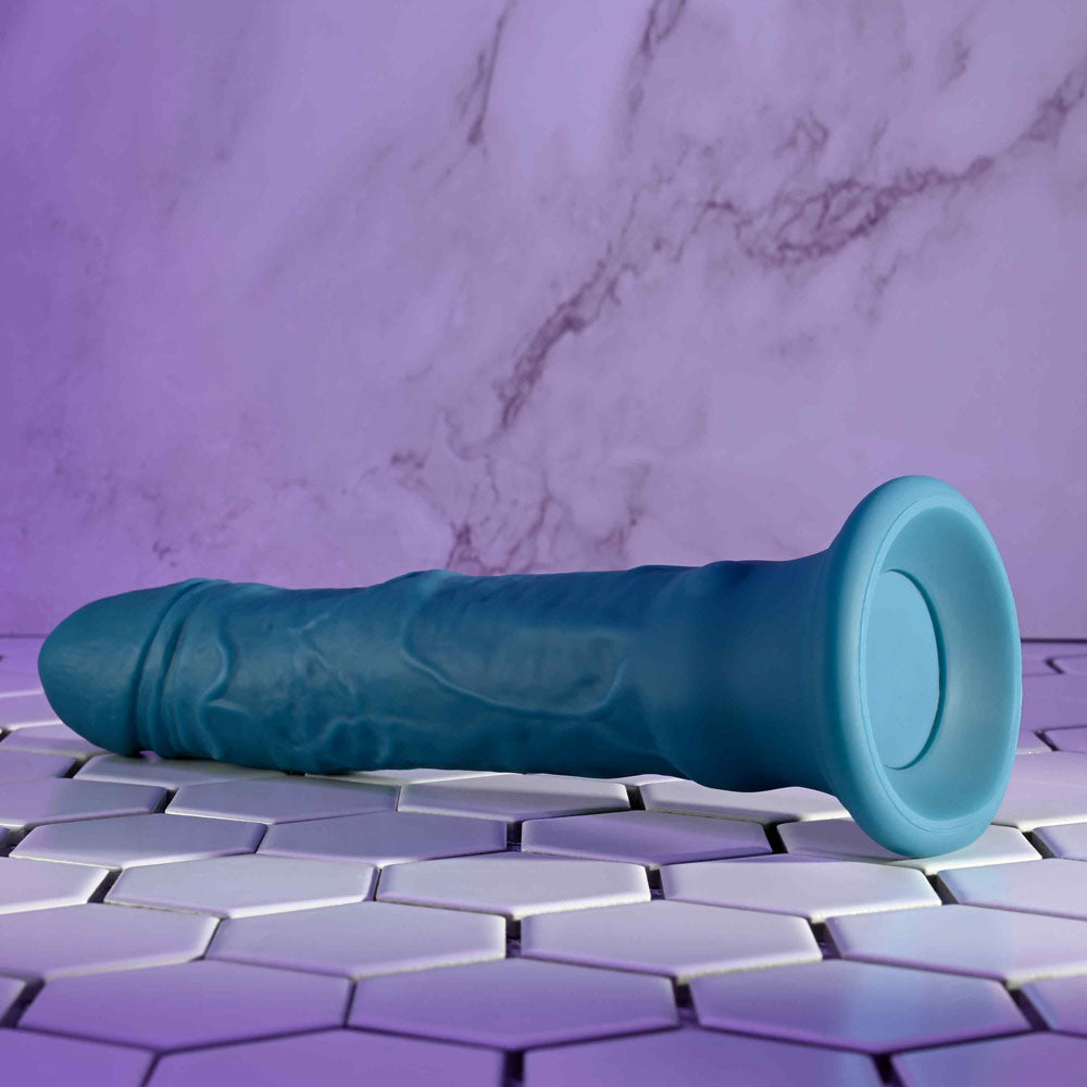 Evolved TSUNAMI -  18.4 cm USB Rechargeable Vibrating Dong with Remote Control on a tiled surface.