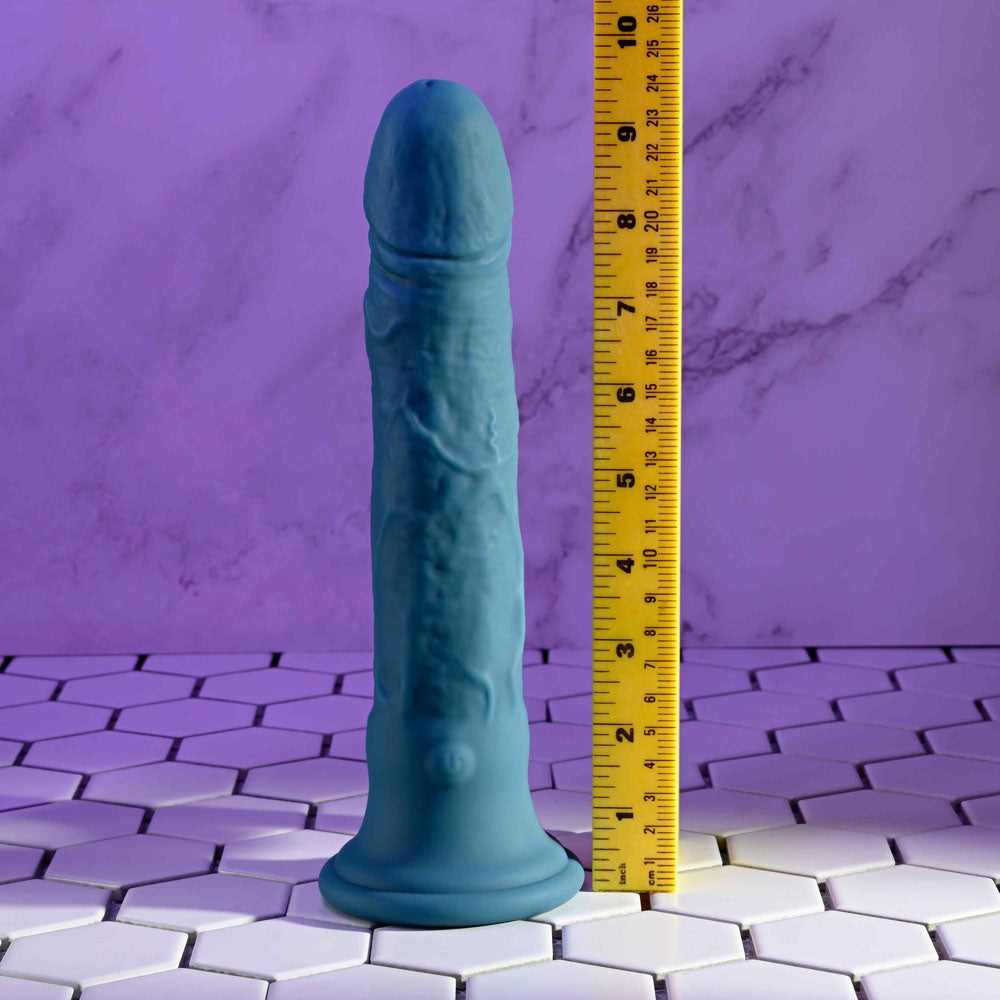 Evolved TSUNAMI -  18.4 cm USB Rechargeable Vibrating Dong with Remote Control beside a ruler for size reference.