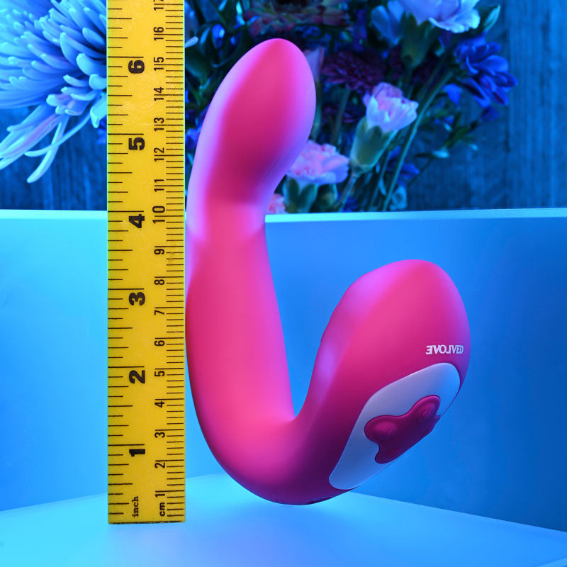 Evolved BUCK WILD -  USB Rechargeable Flicking Vibrator next to a ruler for size comparison, vibrant pink design.