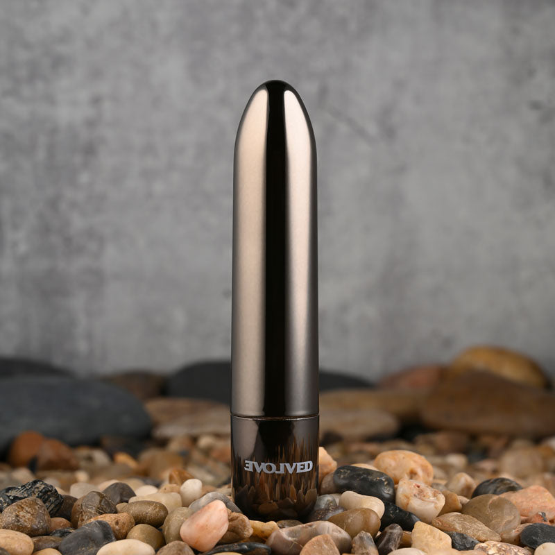 Evolved REAL SIMPLE - Black 10 cm USB Rechargeable Bullet on pebbled surface, sleek design for intimate essentials.
