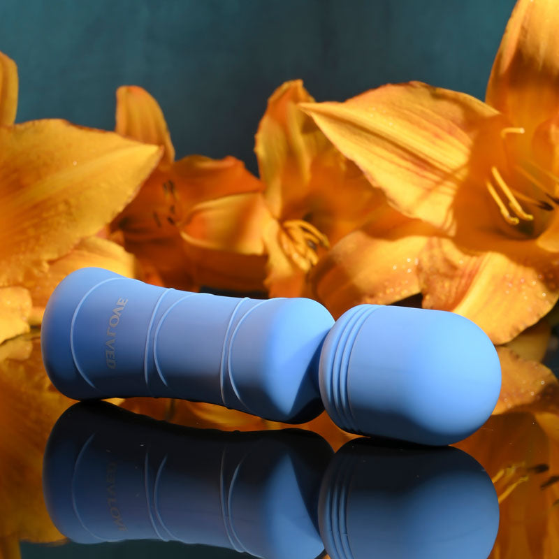 Evolved Out Of The  -  10.5 cm USB Rechargeable Mini Massager Wand against vibrant flowers.