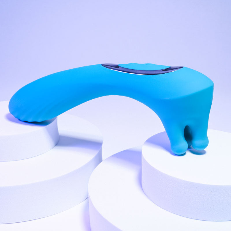 Evolved HEADS OR TAILS - Blue 19.3 cm USB Rechargeable Dual Ended Massager displayed on white pedestals.
