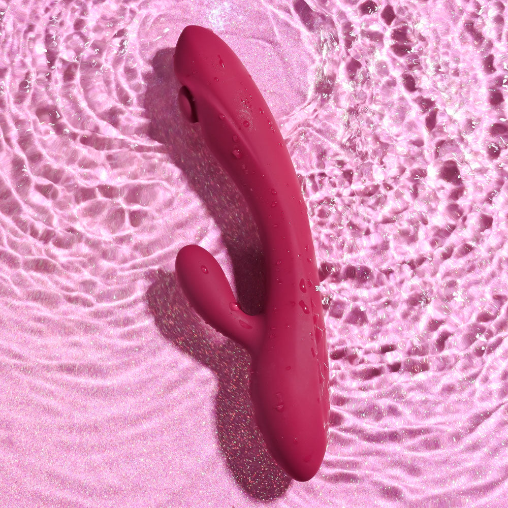 Evolved JAMMIN' G - Burgundy 20.1 cm USB Rechargeable Rabbit Vibrator resting in water, showcasing its sleek design.