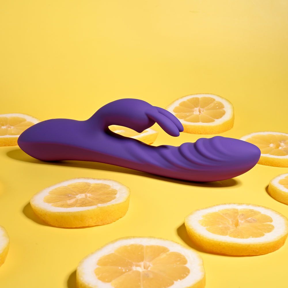 Evolved WAVY RABBIT - 20.6 cm USB Rechargeable Rabbit Vibrator on yellow background with lemon slices.