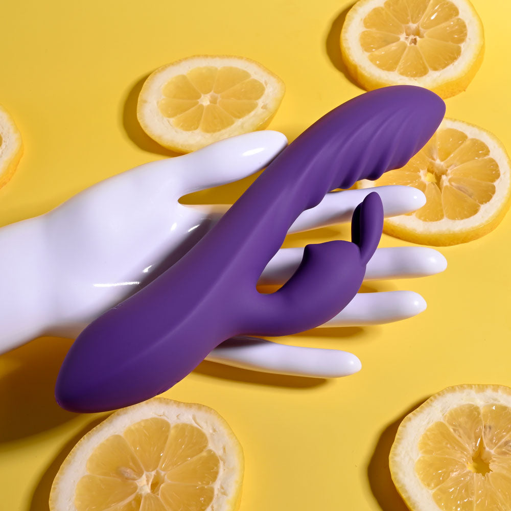 Evolved WAVY RABBIT - 20.6 cm USB Rechargeable Rabbit Vibrator displayed on a hand surrounded by lemon slices.