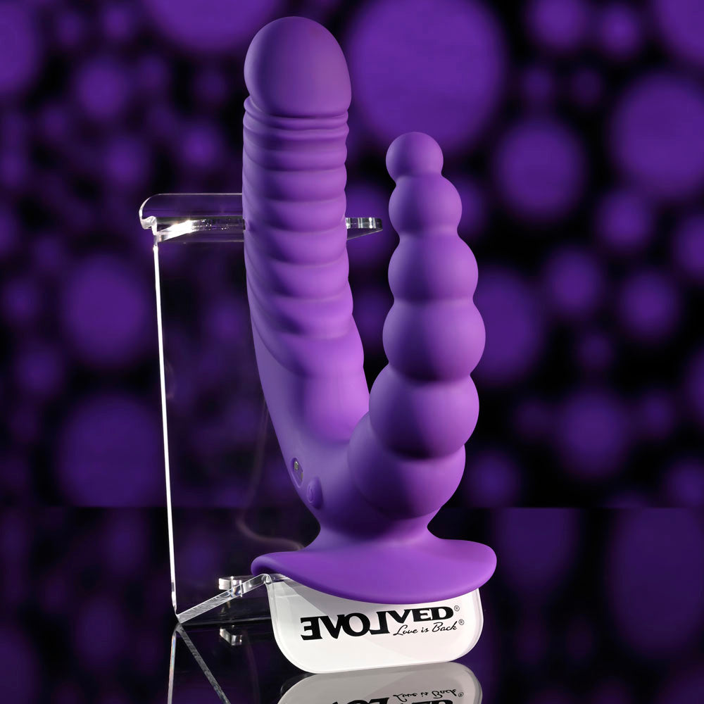 Evolved THE RIDER - USB Rechargeable Double Ended Vibrator with Wireless Remote on display with a purple background.