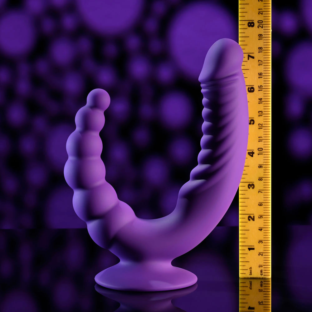 Evolved THE RIDER -  USB Rechargeable Double Ended Vibrator with Wireless Remote on a measuring scale with purple background.