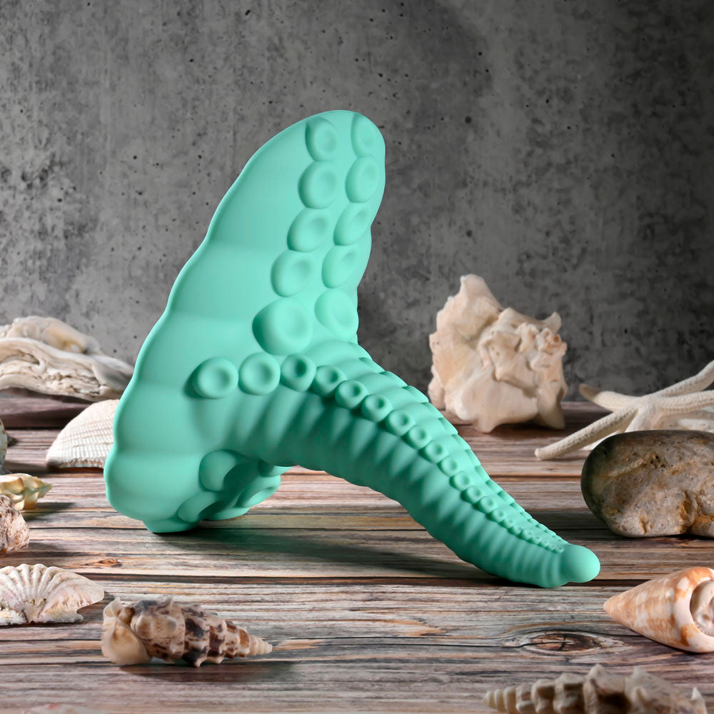 Evolved TENTACLE GRINDER -  USB Rechargeable Fantasy Grinder Pad with Wireless Remote on a table with seashells.