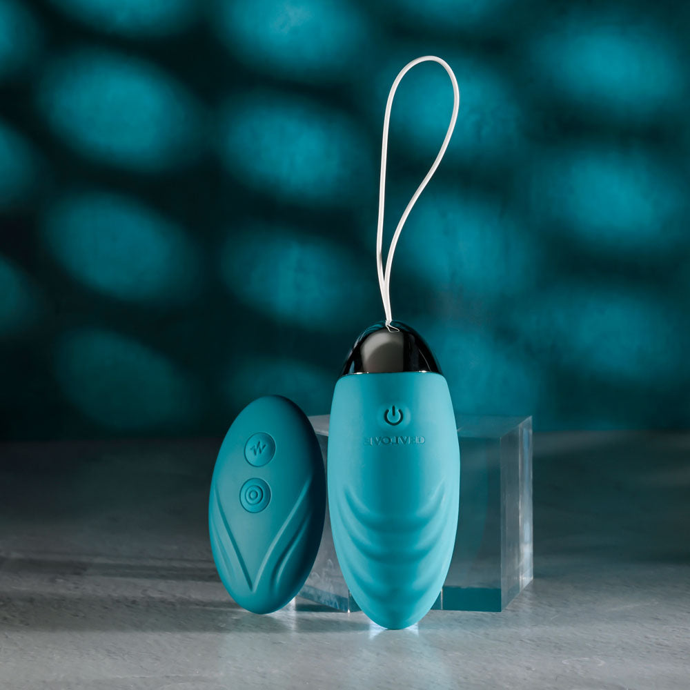 Evolved OVAL OFFICE remote control vibrating egg with ergonomic design and remote, in vibrant turquoise color.