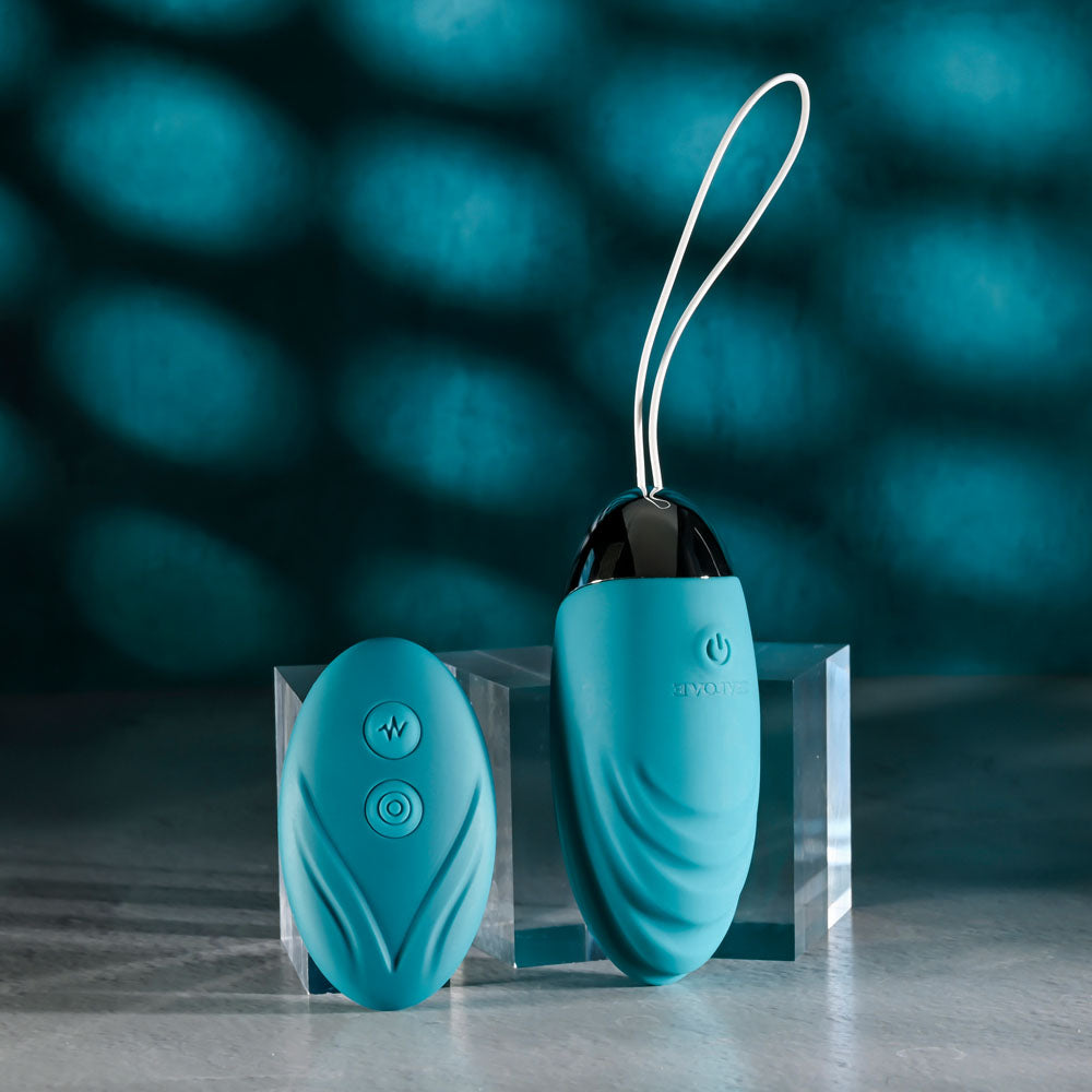 Evolved OVAL OFFICE remote control vibrating egg with USB rechargeable design and remote control on a surface.