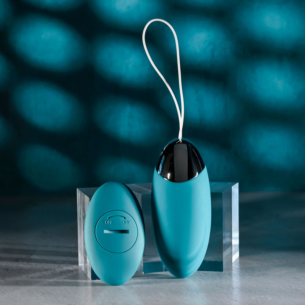 Evolved OVAL OFFICE remote control vibrating egg with a sleek design and remote on a clear display.