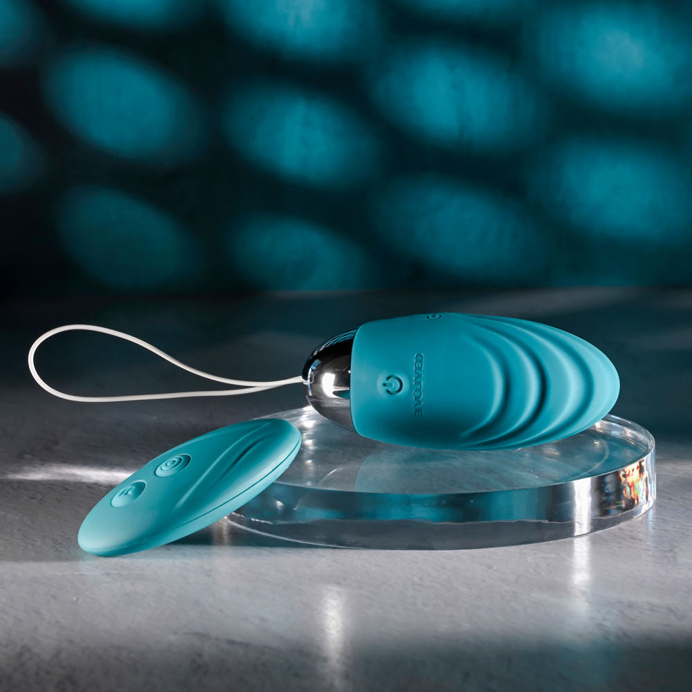 Evolved OVAL OFFICE -  8.5 cm USB Rechargeable Wireless Egg with Remote Control on a clear surface.