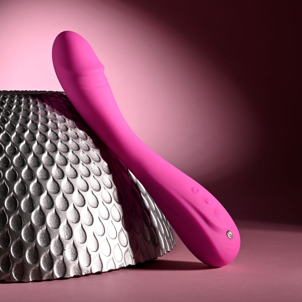 Evolved SUGAR RUSH - 21.6 cm USB Rechargeable Vibrator on textured surface with pink design for intimate essentials for her.