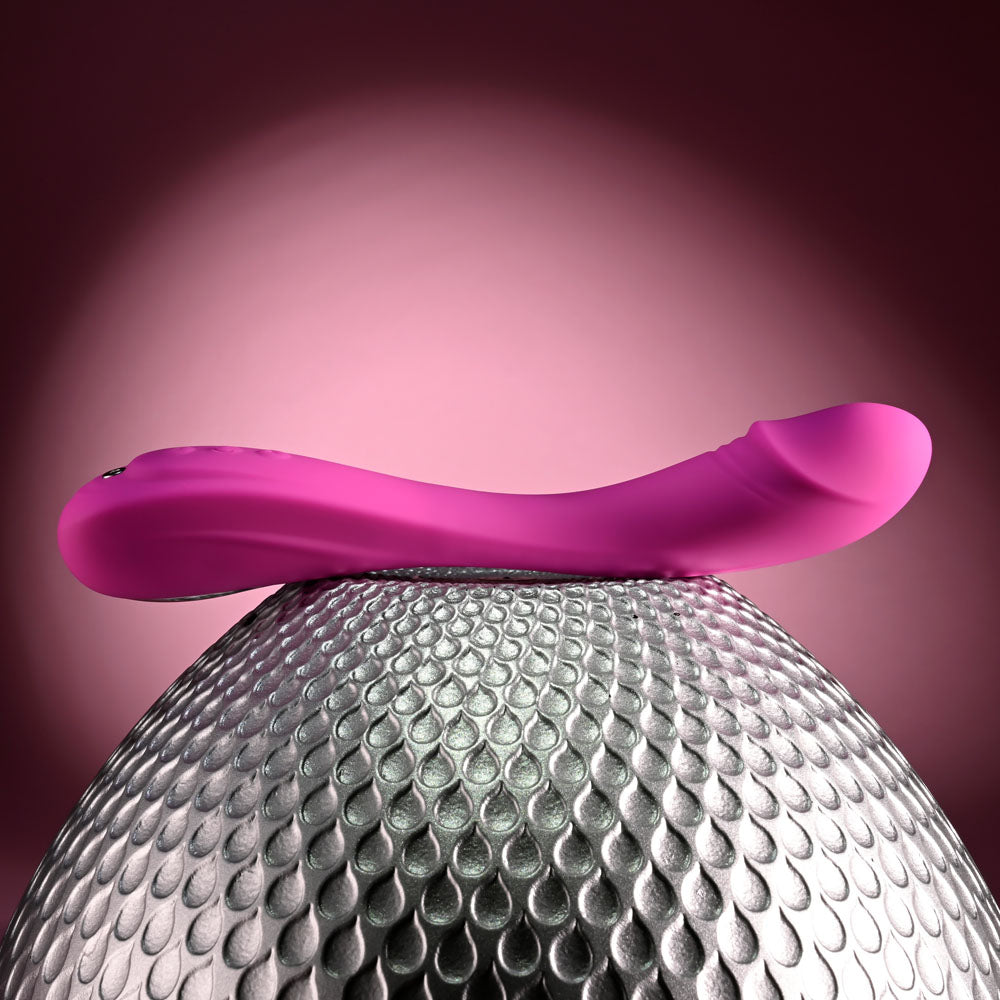 Evolved SUGAR RUSH - 21.6 cm USB Rechargeable Vibrator displayed on textured surface, showcasing elegant design.