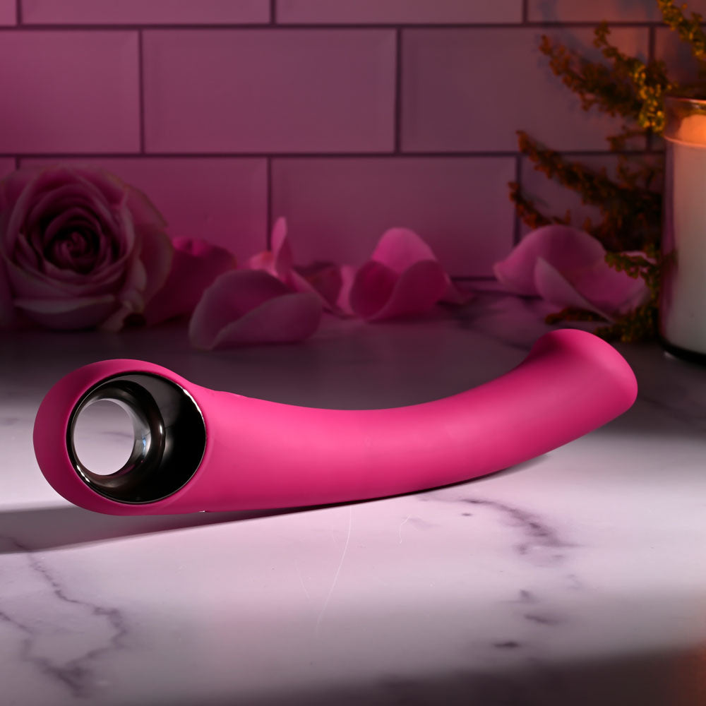 Evolved PLEASURE CURVE -  19 cm USB Rechargeable Vibrator on a marble surface with roses.