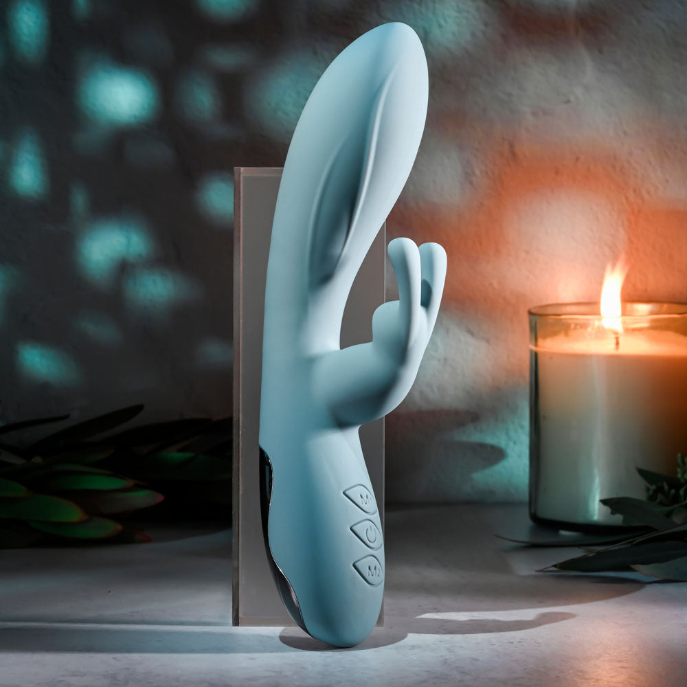 Evolved BOSS BUNNY - Baby 20.1 cm USB Rechargeable Rabbit Vibrator displayed with soothing candlelight ambiance.