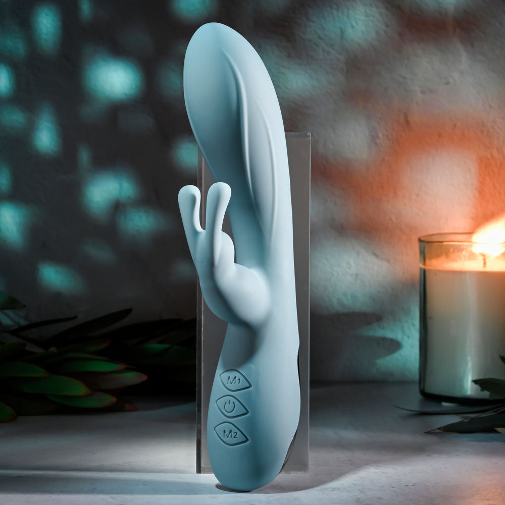 Evolved BOSS BUNNY - Baby 20.1 cm USB Rechargeable Rabbit Vibrator displayed elegantly beside a lit candle.