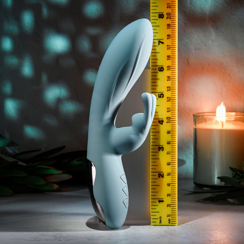 Evolved BOSS BUNNY - Baby 20.1 cm USB Rechargeable Rabbit Vibrator beside a measuring tape and candles.