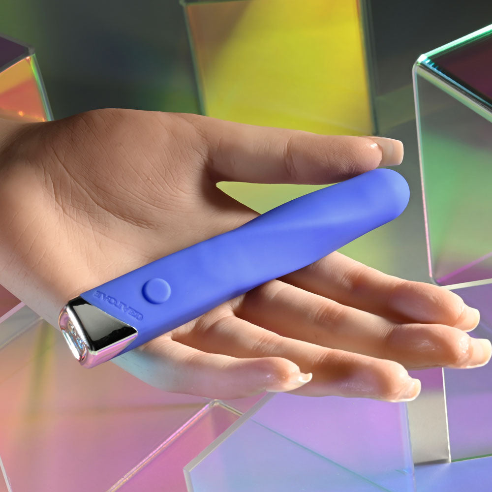Evolved TWISTED TEMPTATION - 12 cm USB Rechargeable Bullet in a hand with colorful background.