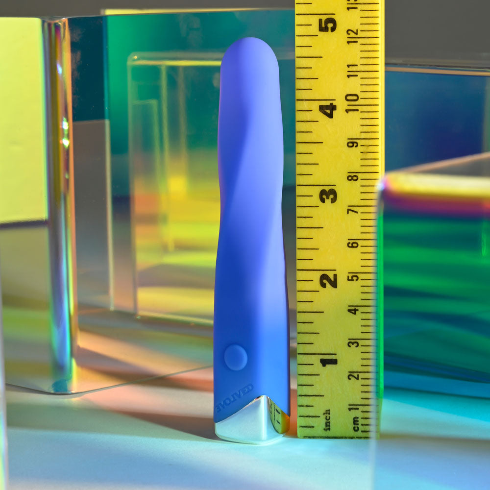 Evolved TWISTED TEMPTATION - 12 cm USB Rechargeable Bullet next to a ruler for size comparison in a colorful setting.