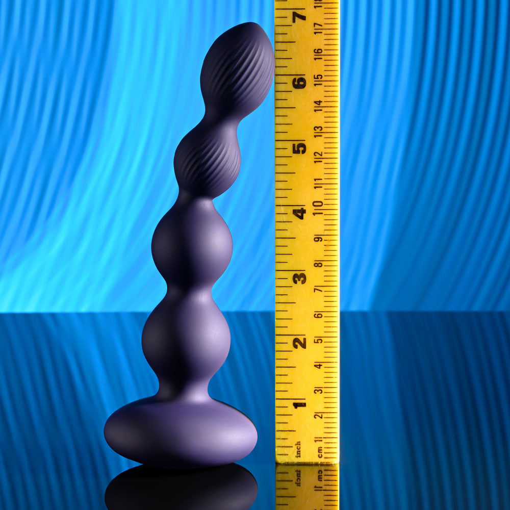 Evolved PLEASURE ORBIT - Navy  17.8 cm USB Rechargeable Twirling & Vibrating Anal Beads with Remote displayed next to a ruler.