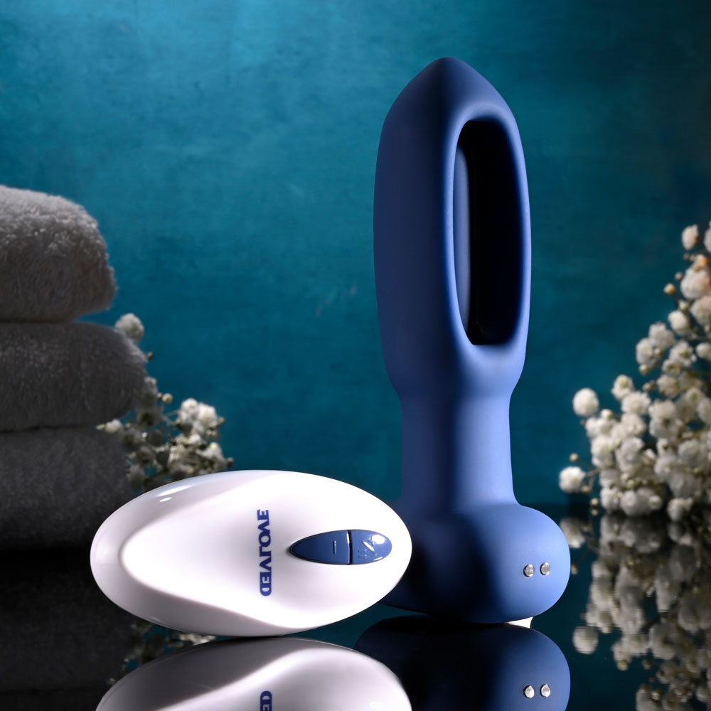 Evolved THE FLAPPER - 14 cm USB Rechargeable Vibrating and Flapping Butt Plug with Remote on a stylish background.