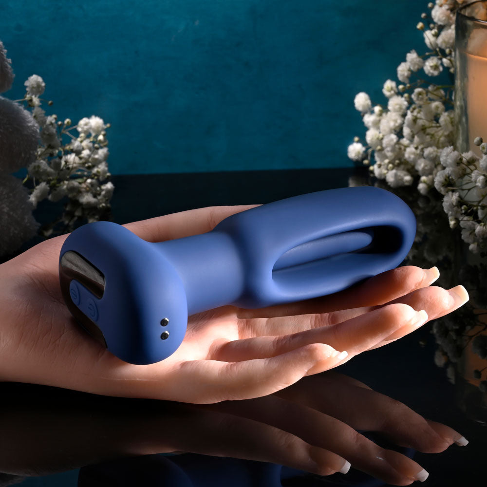 Evolved THE FLAPPER - 14 cm USB Rechargeable Vibrating and Flapping Butt Plug with Remote in hand with intimate essentials.