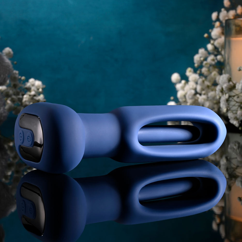 Evolved THE FLAPPER - 14 cm USB Rechargeable Vibrating and Flapping Butt Plug with Remote on a reflective surface.