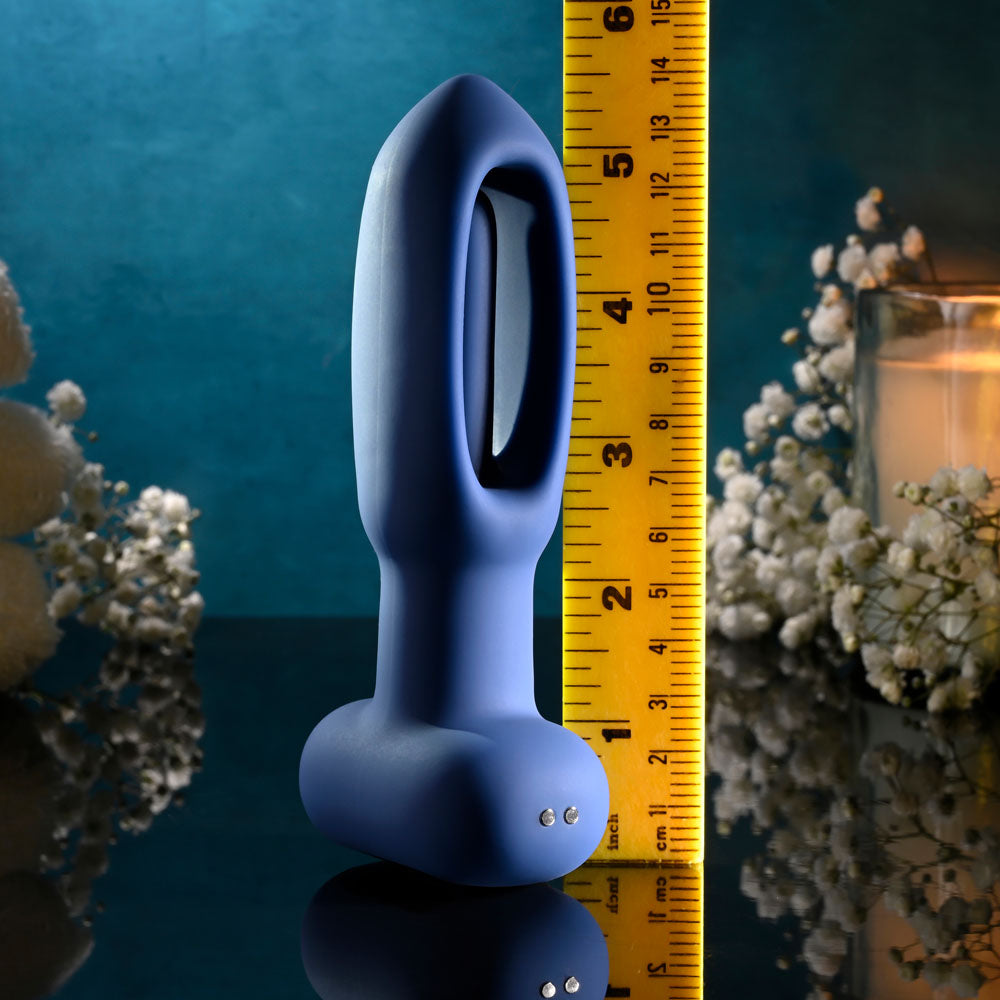 Evolved THE FLAPPER - 14 cm USB Rechargeable Vibrating and Flapping Butt Plug with Remote against a decorative background.