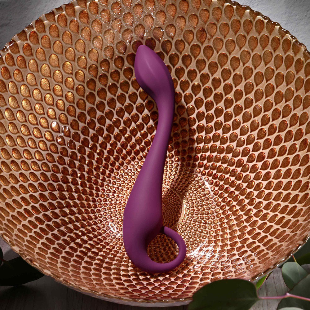 Evolved LOCHNESS G - 19 cm USB Rechargeable Vibrator resting in a decorative bowl, showcasing its sleek design.