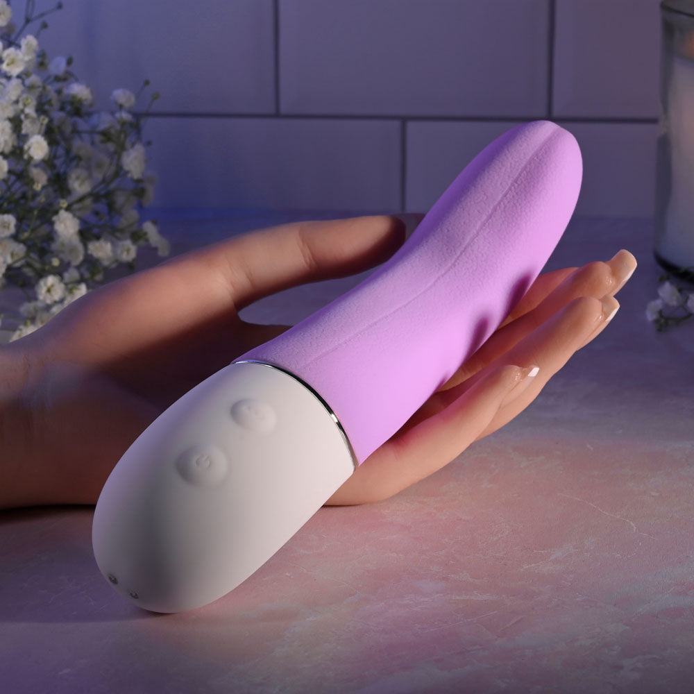 Evolved SLIP OF THE TONGUE - 21.1 cm USB rechargeable flicking tongue vibrator in a hand.