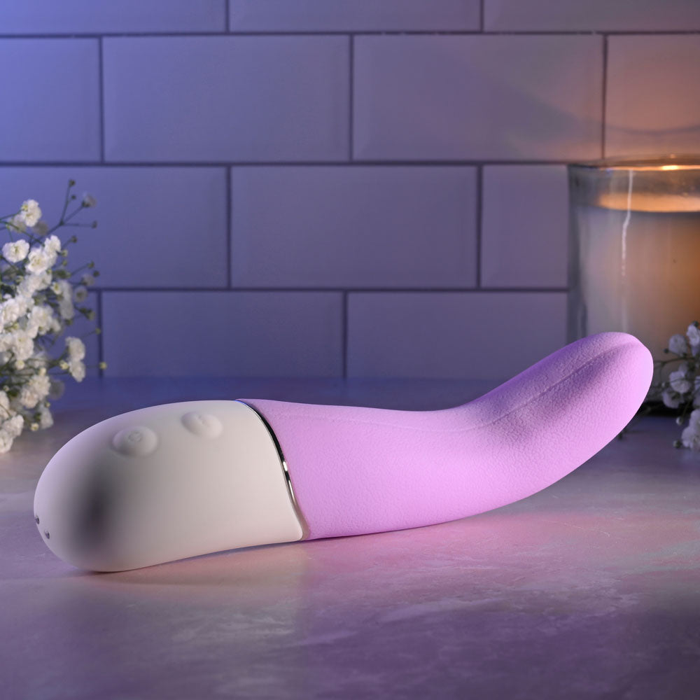 Evolved SLIP OF THE TONGUE - 21.1 cm USB Rechargeable Flicking Tongue Vibrator on a textured surface with flowers.