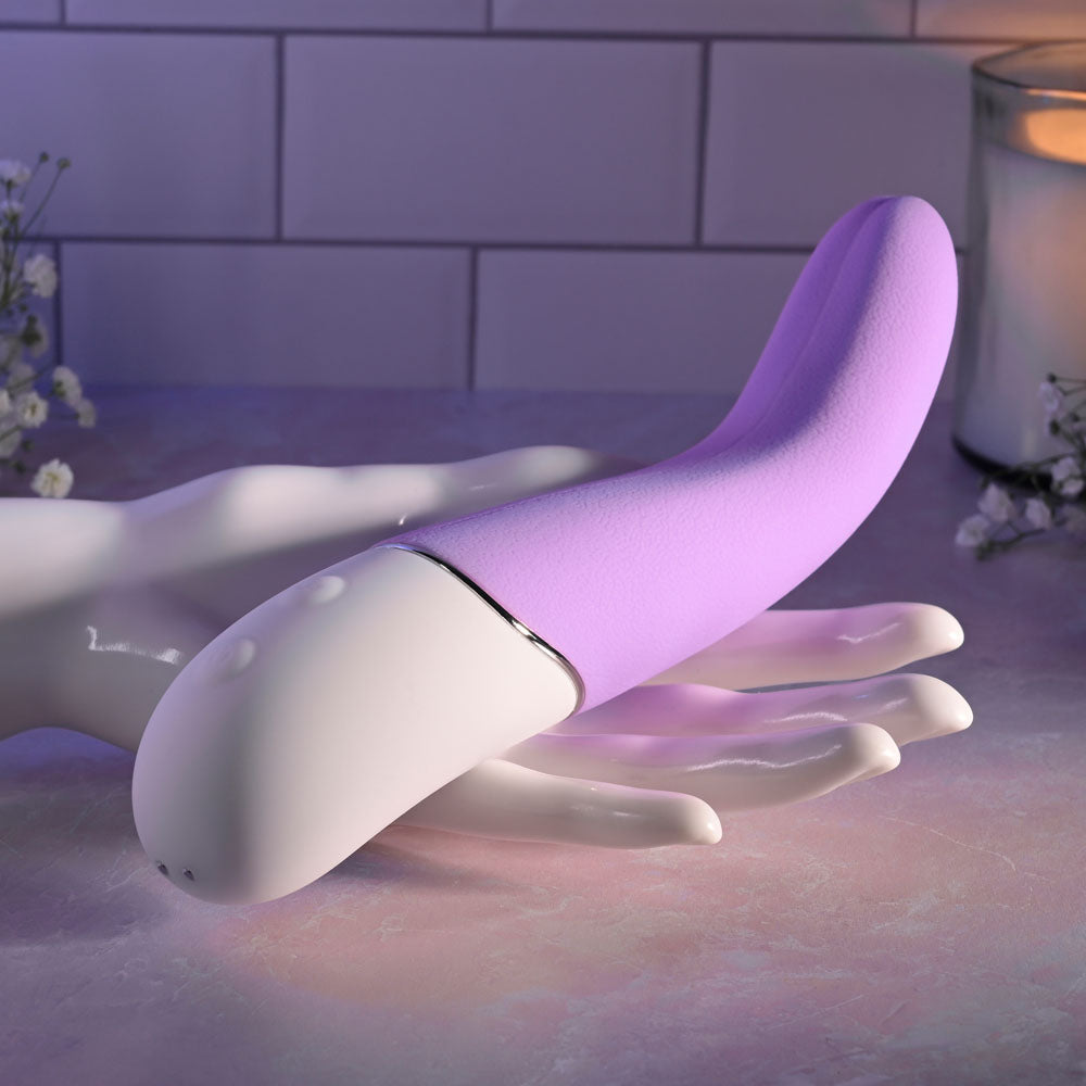 Evolved SLIP OF THE TONGUE - 21.1 cm USB Rechargeable Flicking Tongue Vibrator resting on a hand.
