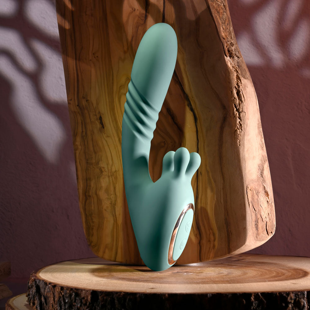 Evolved THRUST INTO ECSTASY - 21 cm USB Rechargeable Thrusting & Rotating Vibrator in teal color on wooden surface.