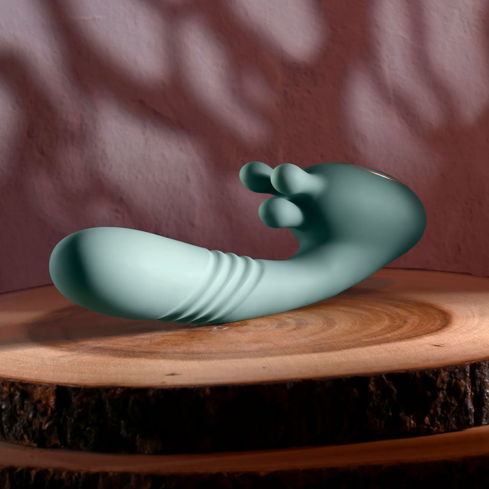 Evolved THRUST INTO ECSTASY - 21 cm USB Rechargeable Thrusting & Rotating Vibrator on wooden surface.