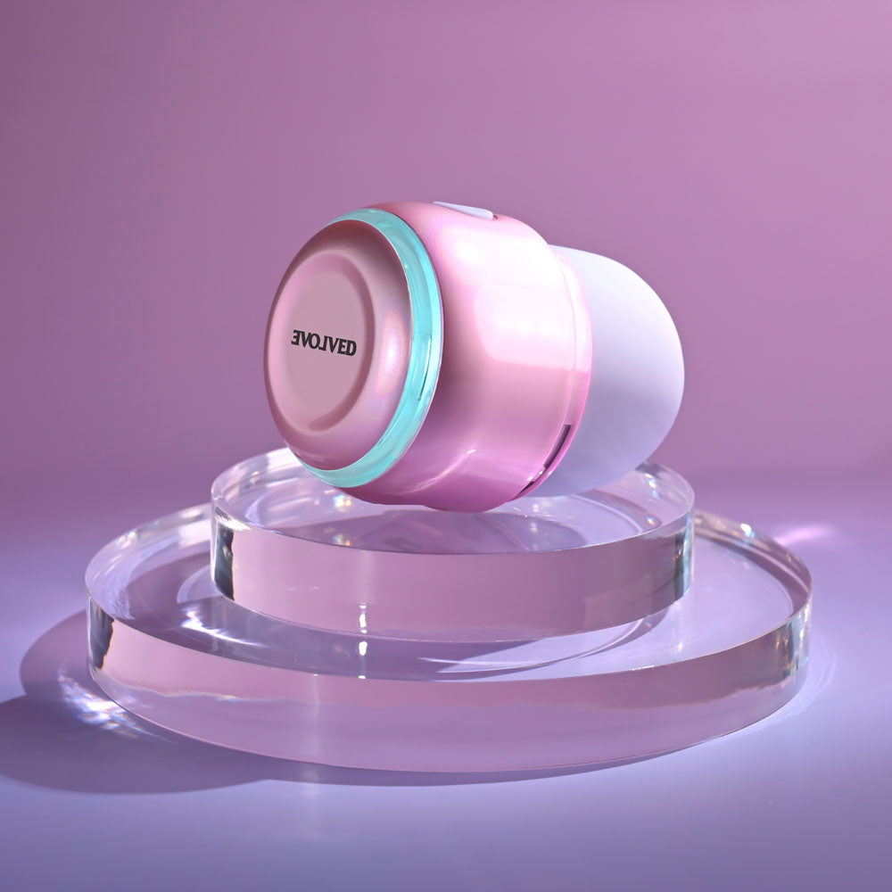 Evolved VACATION VIBES - TAPPING - 8.5 cm USB Rechargeable Tapping Stimulator on a glass surface.