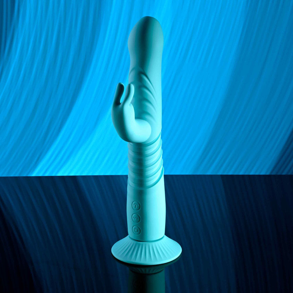 Evolved BUNNY HOP - Teal 25.1 cm USB Rechargeable Thrusting Rabbit Vibrator with Suction Base on a reflective surface.