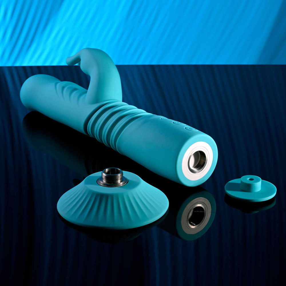 Evolved BUNNY HOP - Teal 25.1 cm USB Rechargeable Thrusting Rabbit Vibrator with Suction Base on a reflective surface.
