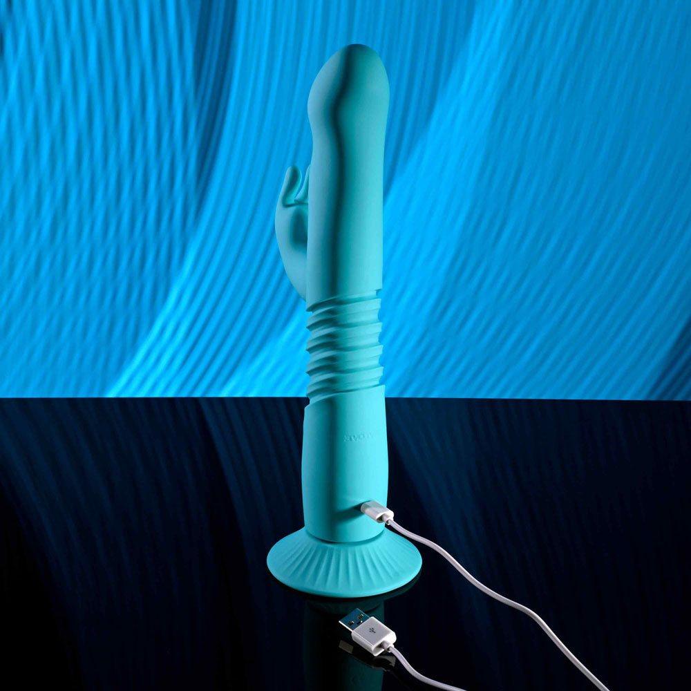 Evolved BUNNY HOP - Teal 25.1 cm USB Rechargeable Thrusting Rabbit Vibrator with Suction Base on a sleek surface.