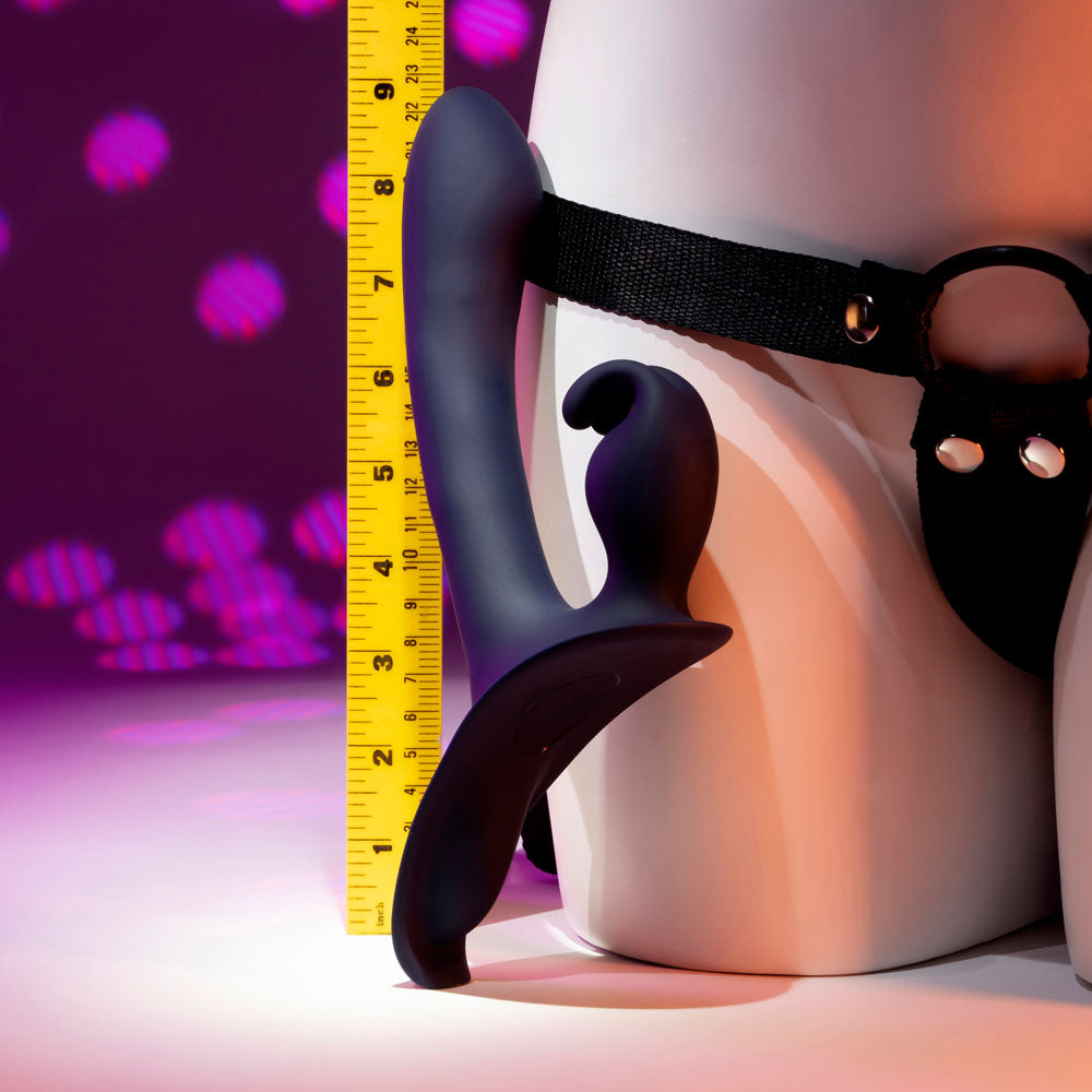 Evolved GIVING VIBES - 14.6 cm USB Rechargeable Vibrating Strap-On with Remote displayed on a body model with measuring tape.